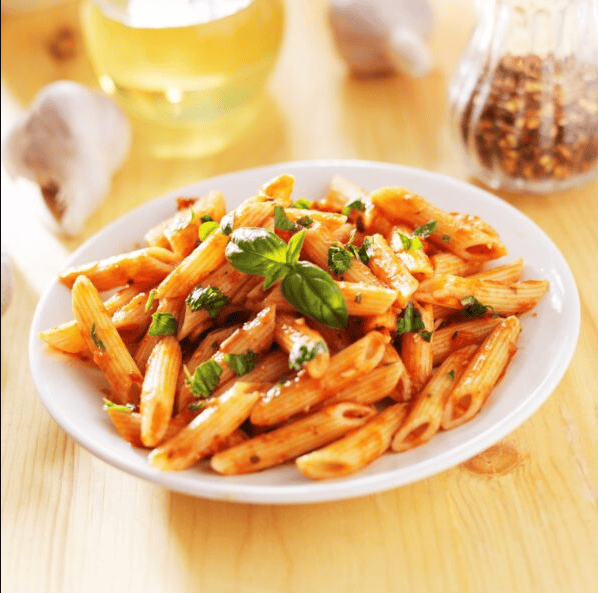 IFFCO premium Penne pasta smothered in rich red tomato sauce, ideal for healthy Mediterranean meals and quick recipes.